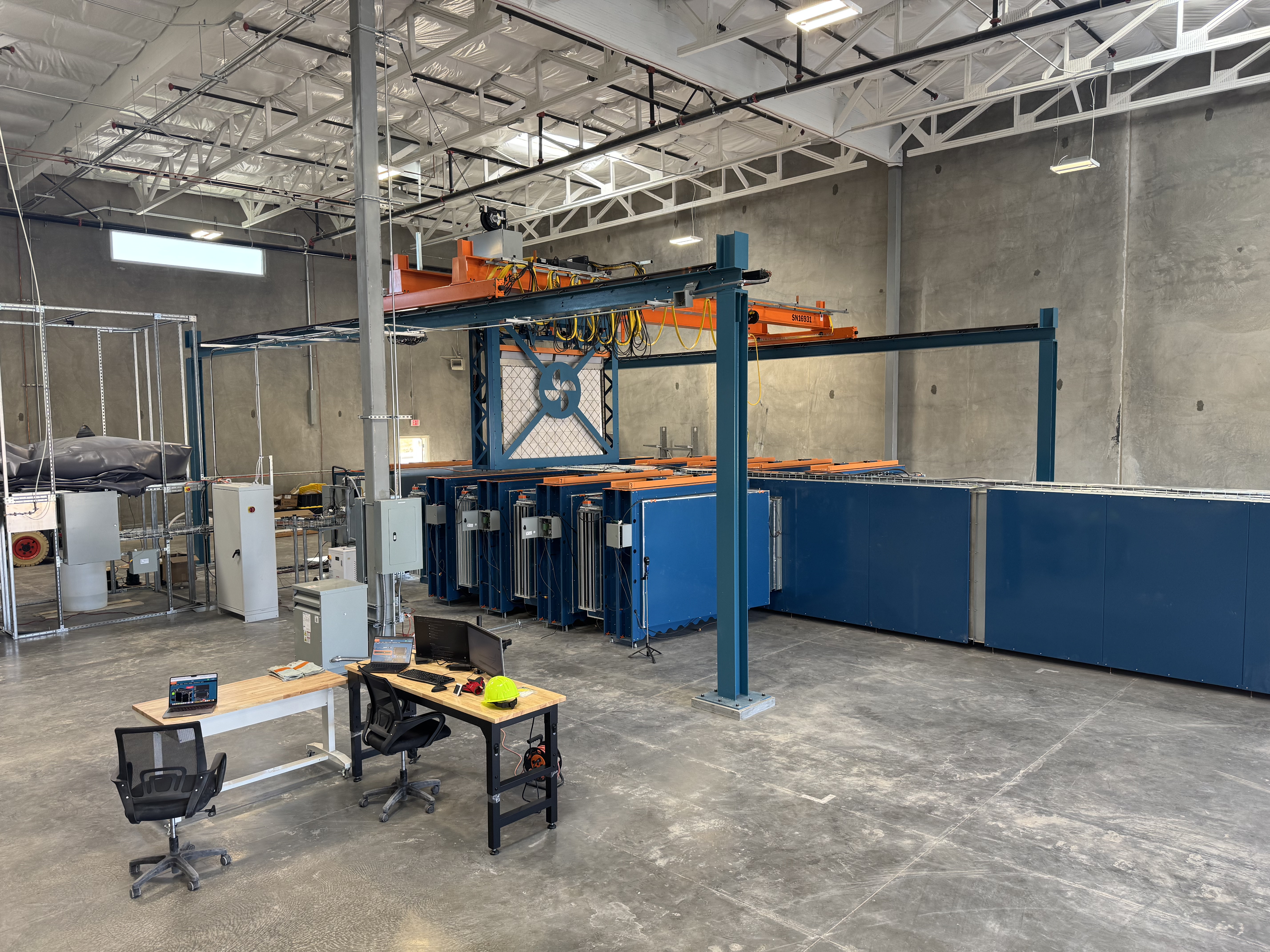 Project Juniper facility interior — crane system and engineering workstations